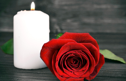 Burning Candle Beside A Rose